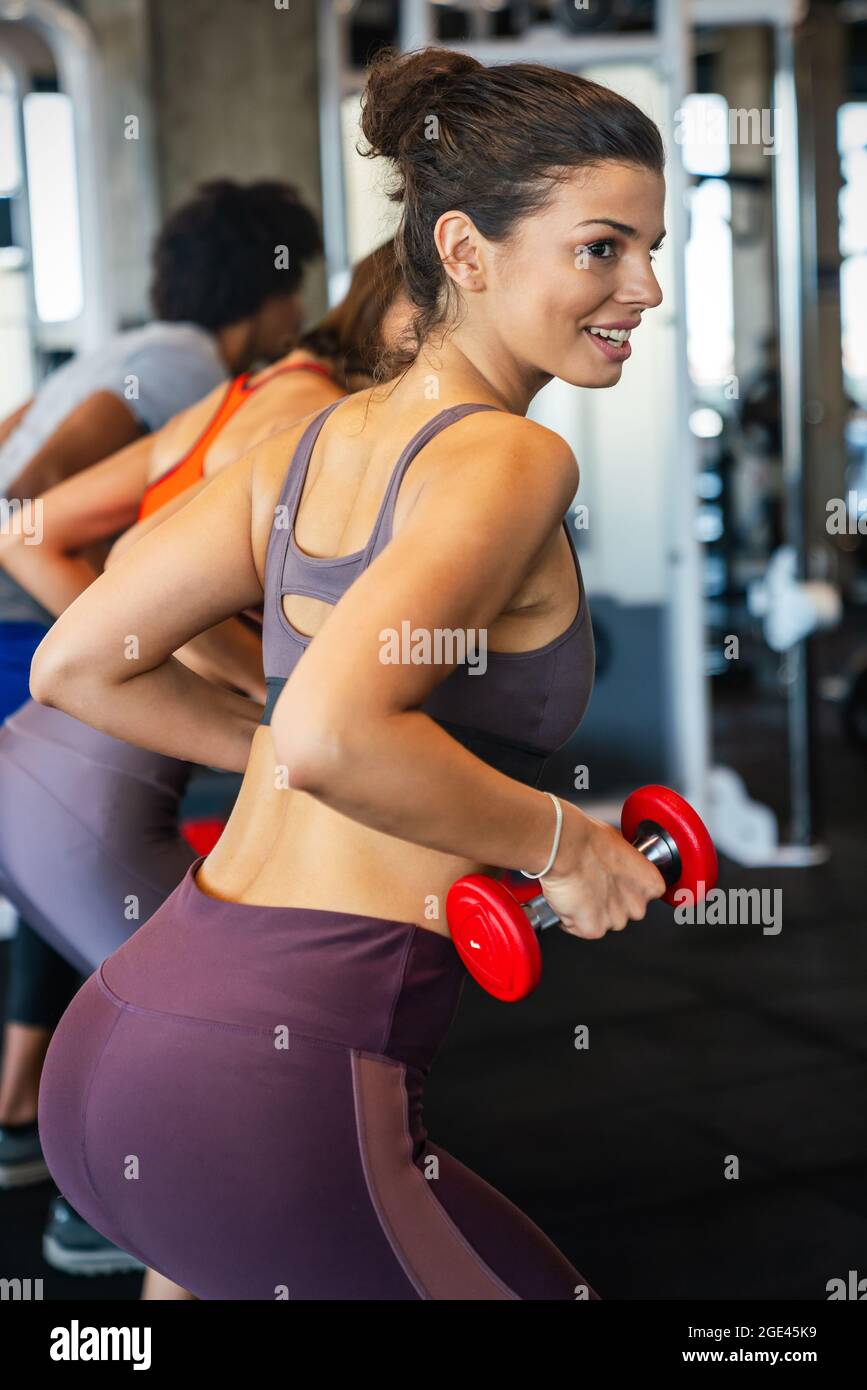 Portrait of happy fit woman exercise in gym to stay healthy Stock Photo ...