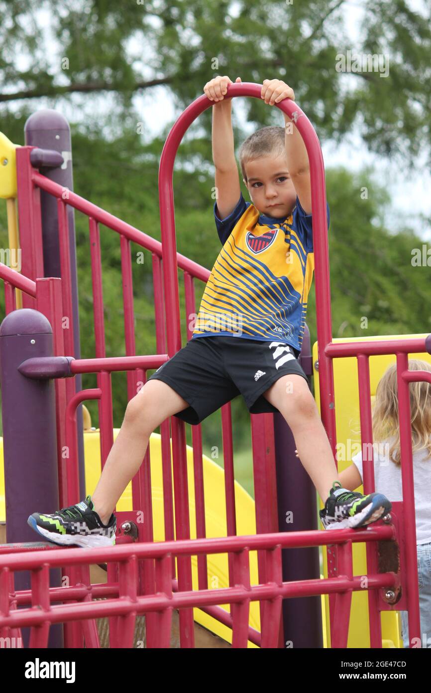 Young boy on a playground with a mischevious look Stock Photo