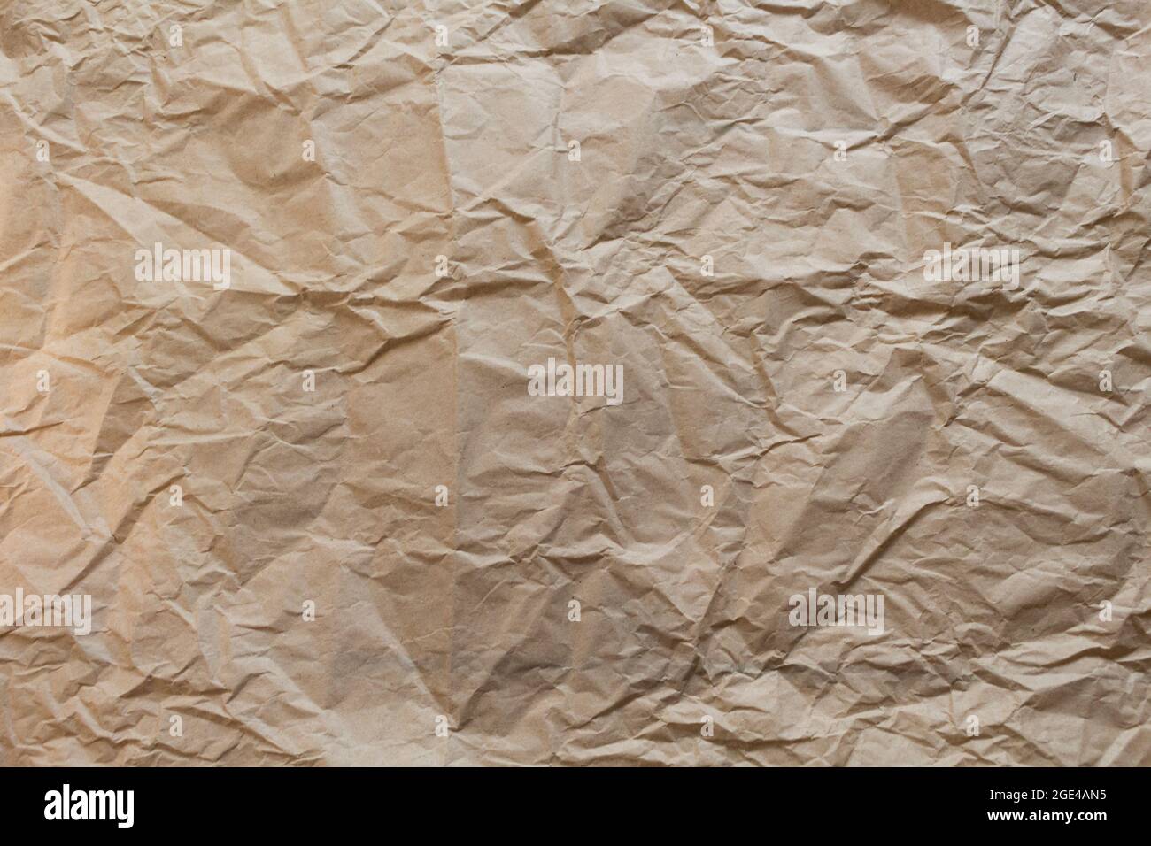 Background of crumpled kraft paper. Background for a shop, web site, in rustic style. Natural lifestyle concept with organic and recycling materials. Stock Photo