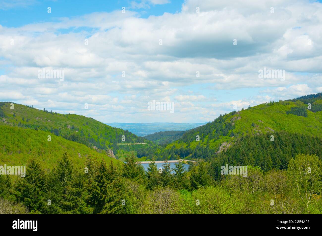 Cloudy sky over the Loire Valley with lush alpine mountainsides and clear blue lake Stock Photo