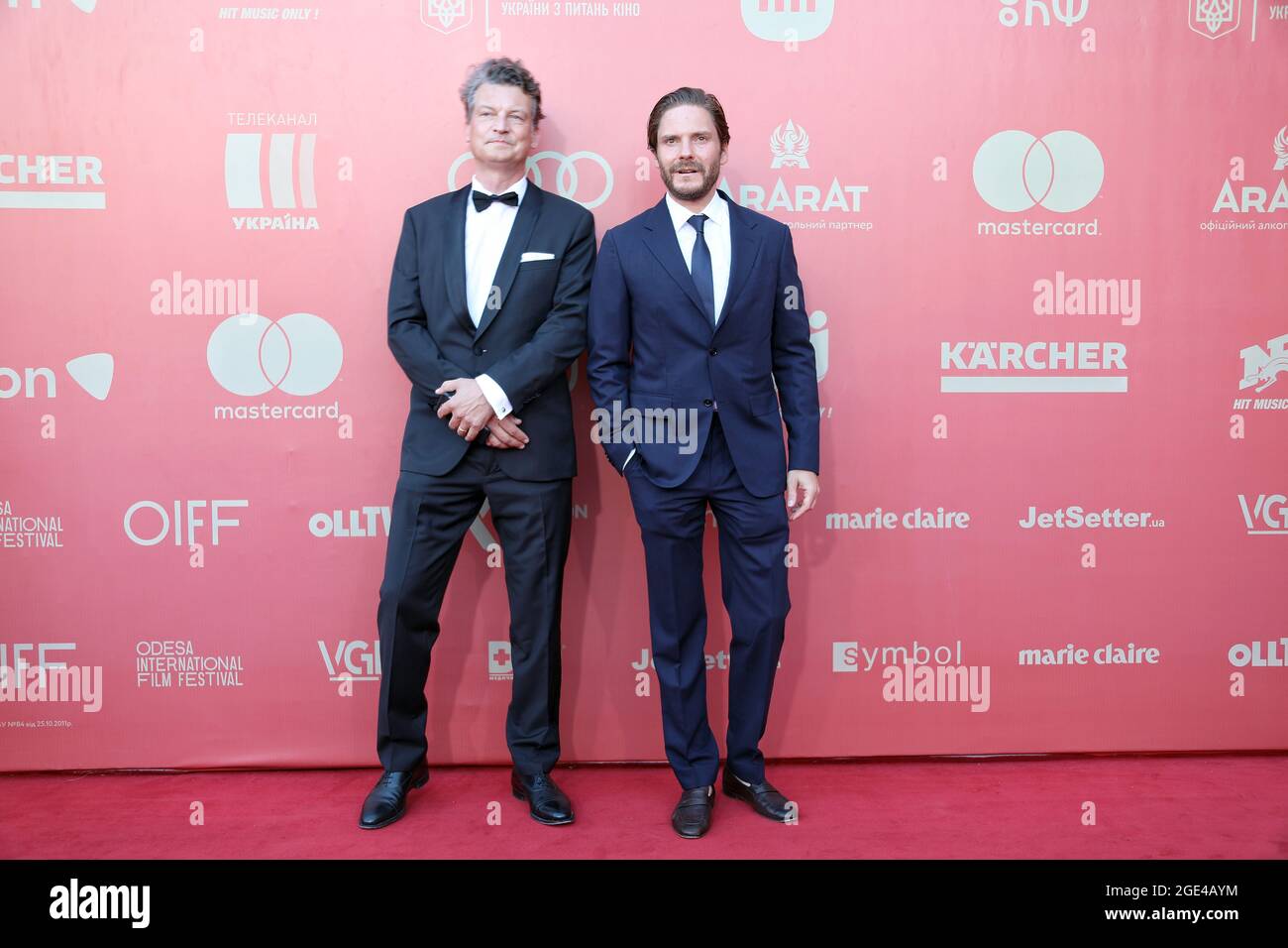 ODESA, UKRAINE - AUGUST 14, 2021 - Spanish-German actor and film director Daniel Bruhl (R) and producer Malte Grunert attend the red carpet event at t Stock Photo