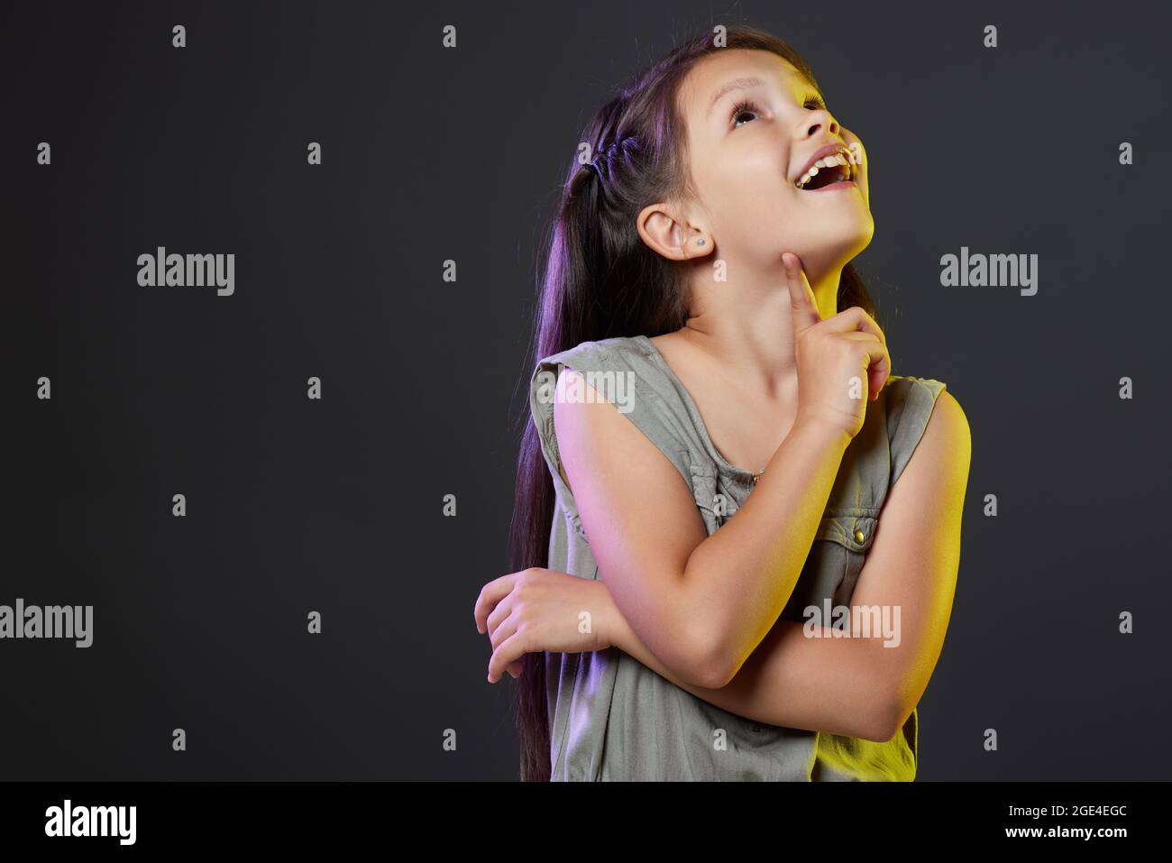 thoughtful little child girl on black background. Stock Photo