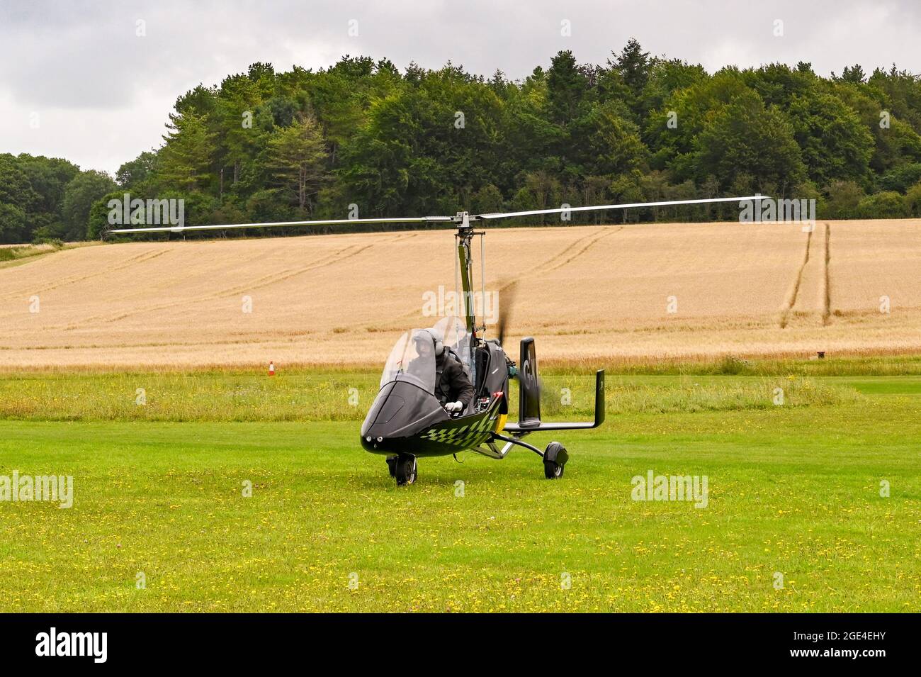 Popham, near Basingstoke, England - August 2021: Single seat gyrocopter taxiing off the grass runway after landing at Popham airfield Stock Photo