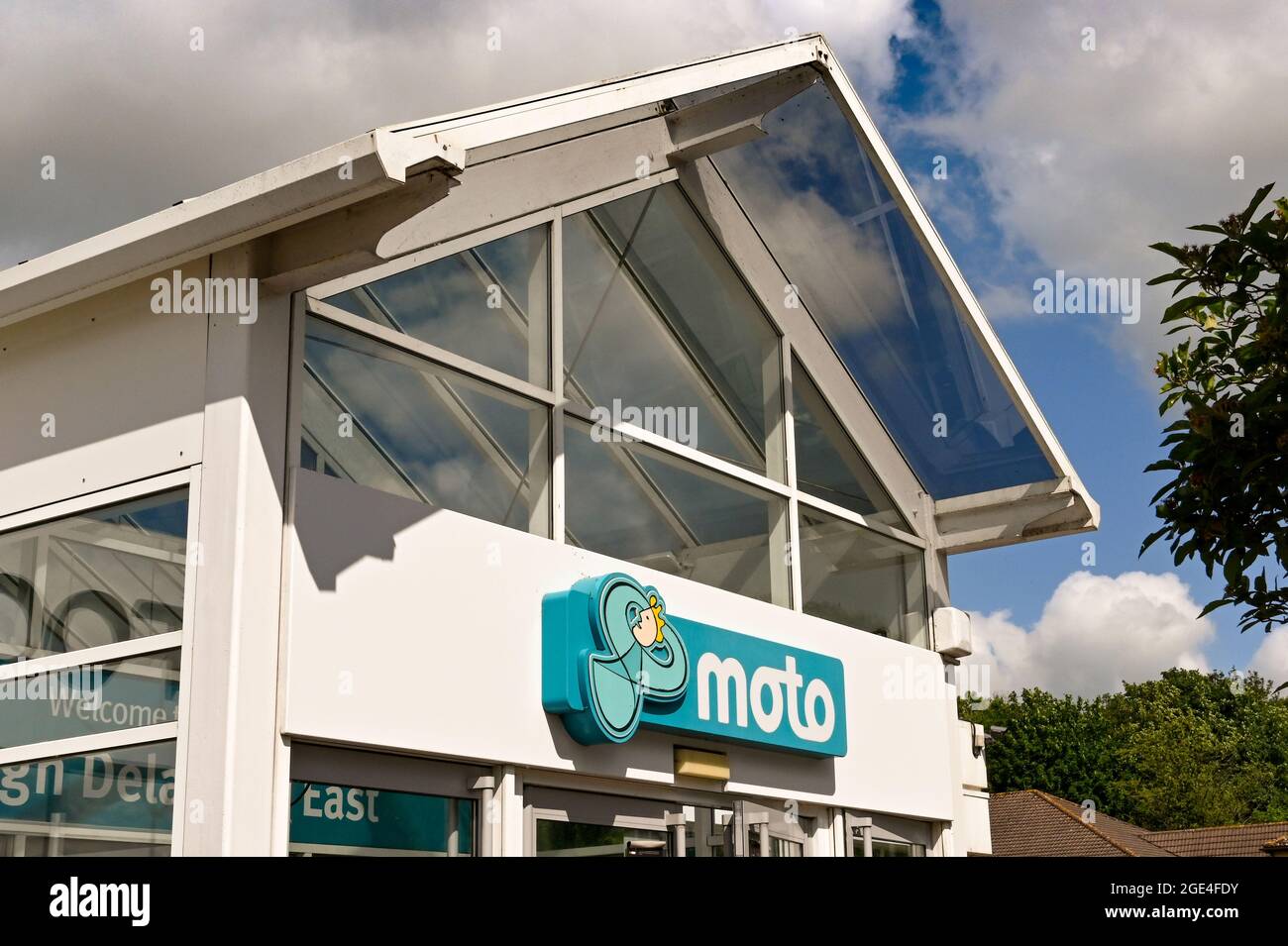 Swindon, England - June 2021: Sign above the entrance to the Moto service station on the M4 at Leigh Delamere Stock Photo