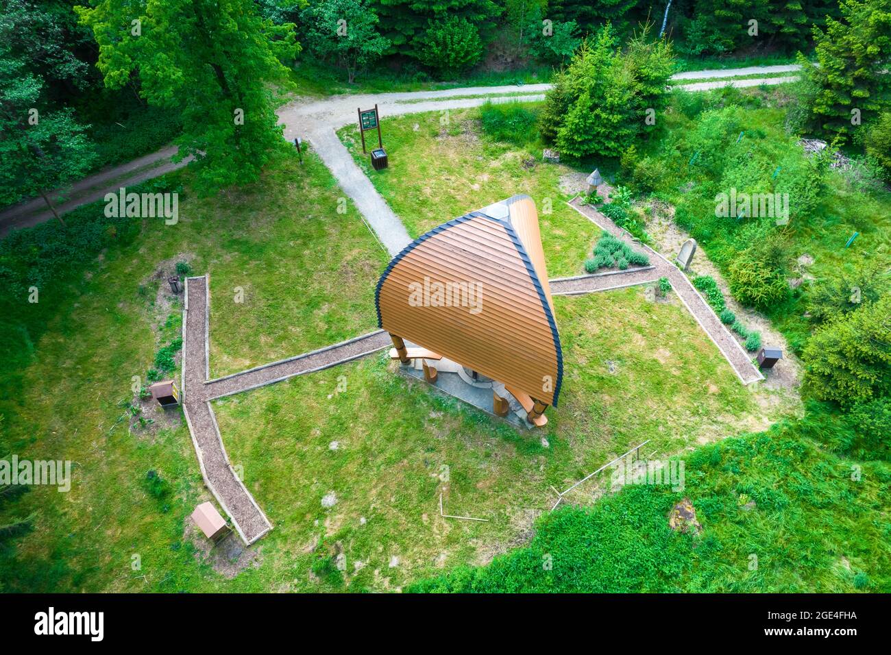 High angle shot of a tent in the meadow in a forest with high ghreen ...