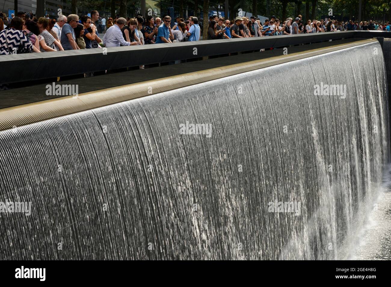 USA, New York City, 9/11 memorial Ground Zero for memory of the victims of terrorist attack of 11th September 2001 at tower of world trade center, water basin, reflecting pool , flowing water, waterfall Stock Photo