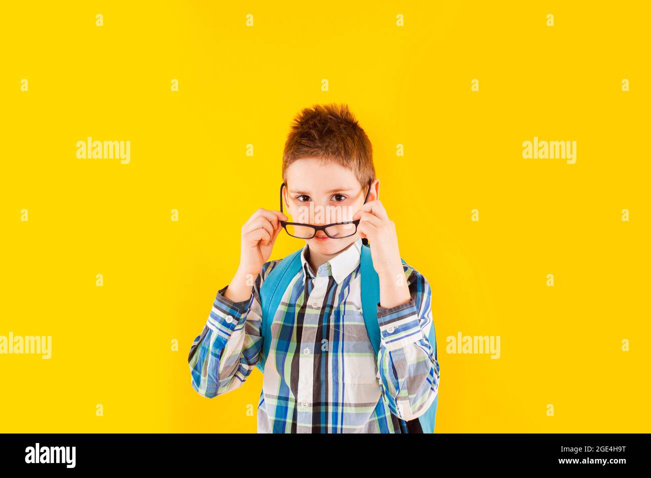 The smart schoolboy shows thumbs up in studio Stock Photo - Alamy