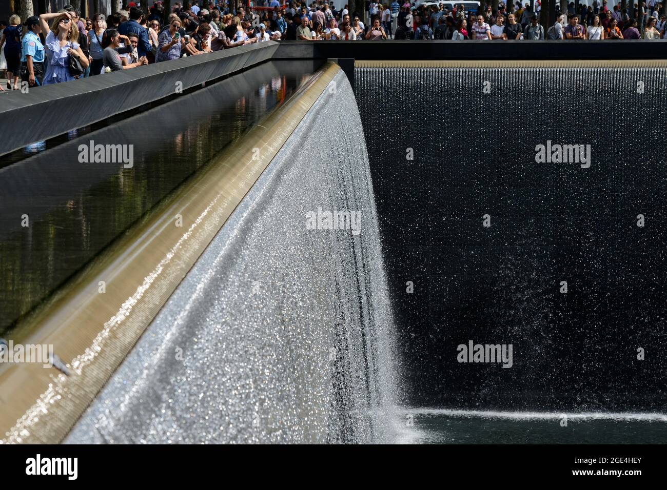 USA, New York City, 9/11 memorial Ground Zero for memory of the victims of terrorist attack of 11th September 2001 at tower of world trade center, water basin, reflecting pool , flowing water, waterfall Stock Photo