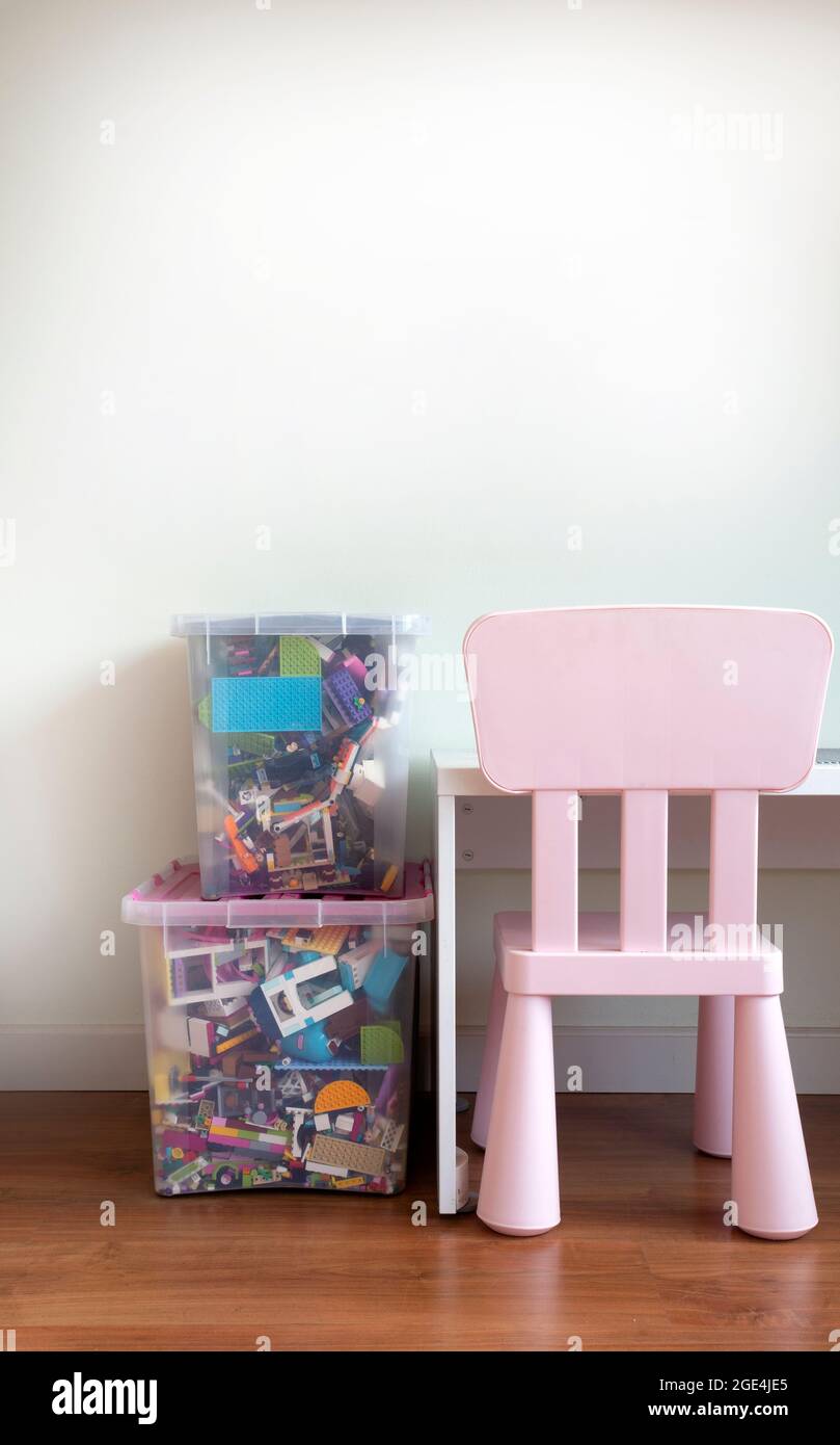 Plastic storage organizer toy box container case with colorful building blocks and other in playroom for children Stock Photo