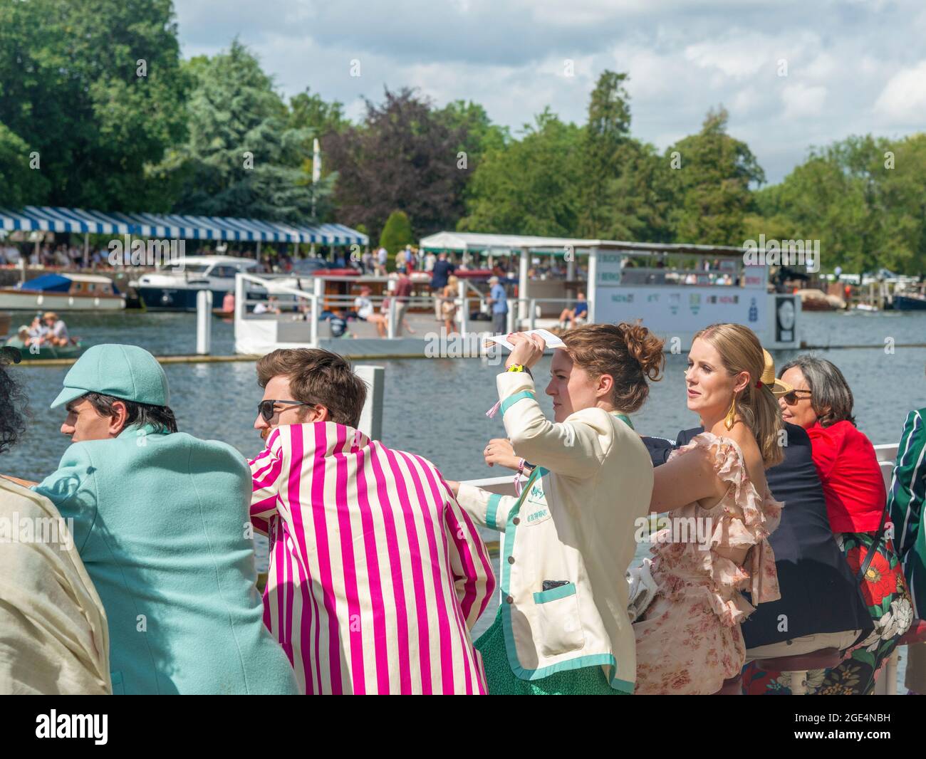 Spectators watch the rowing from the Steward's Enclosure,men wearing rowing club blazers, at the Henley Royal Regatta 2021, Henley-onThames, England Stock Photo