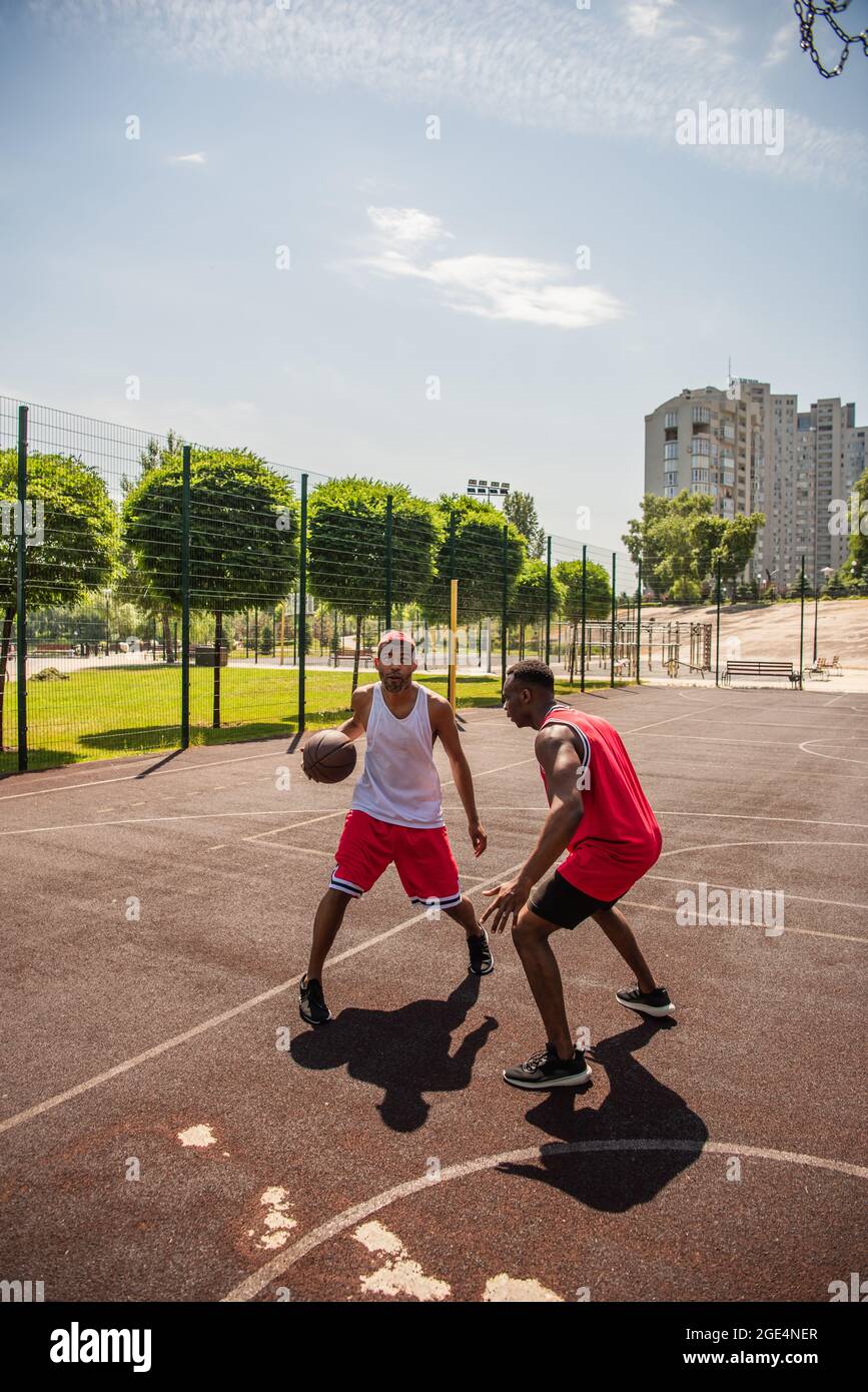 African american sportsmen playing basketball on court Stock Photo - Alamy