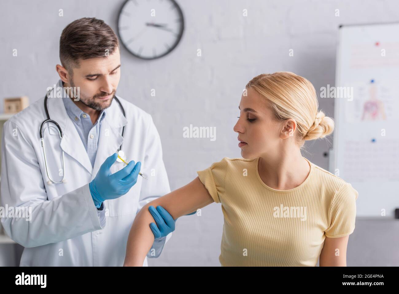 Doctor giving woman injection hi-res stock photography and images - Alamy