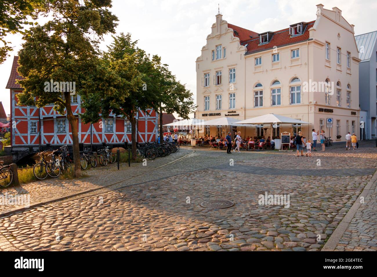wismar, Germany - July 12, 2021: People are sitting and eating at an outdoor restaurant in the game Wismar Stock Photo