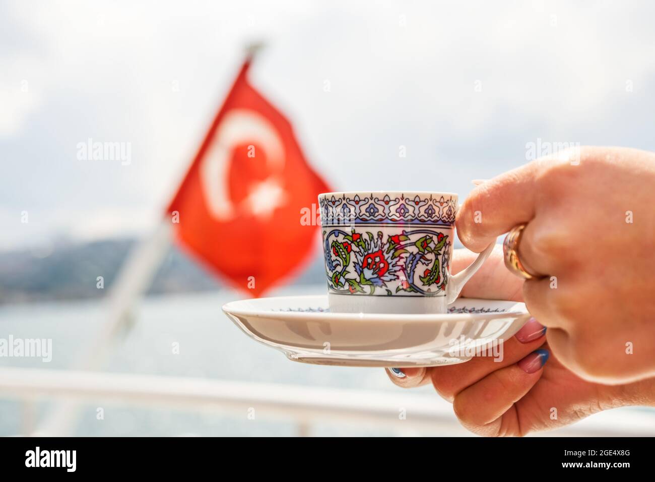 hand with turkish coffee cup and flag. Travel concept Stock Photo