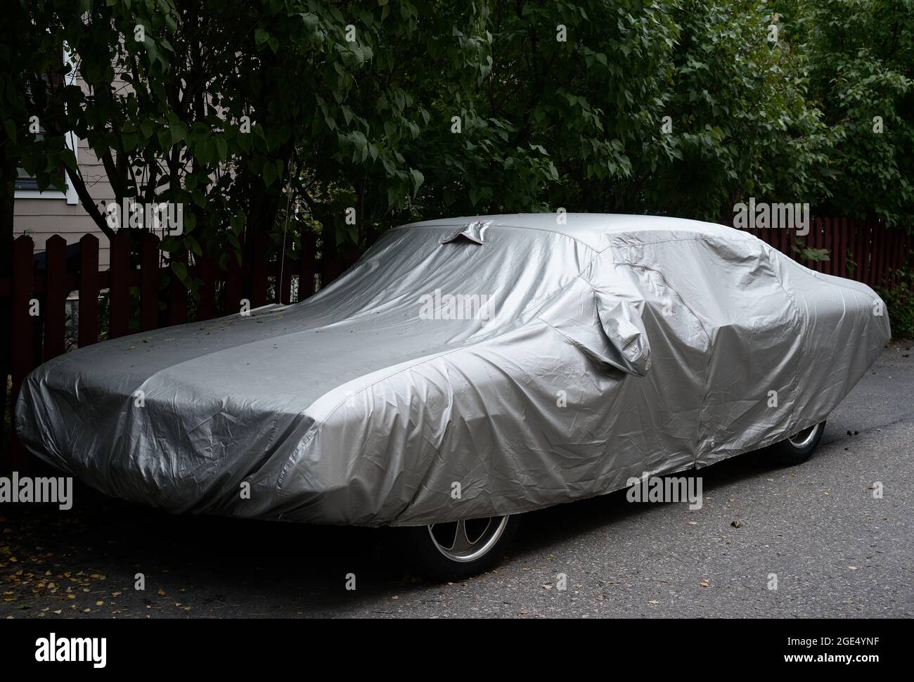 car fully covered with a silver cover, outdoor Stock Photo