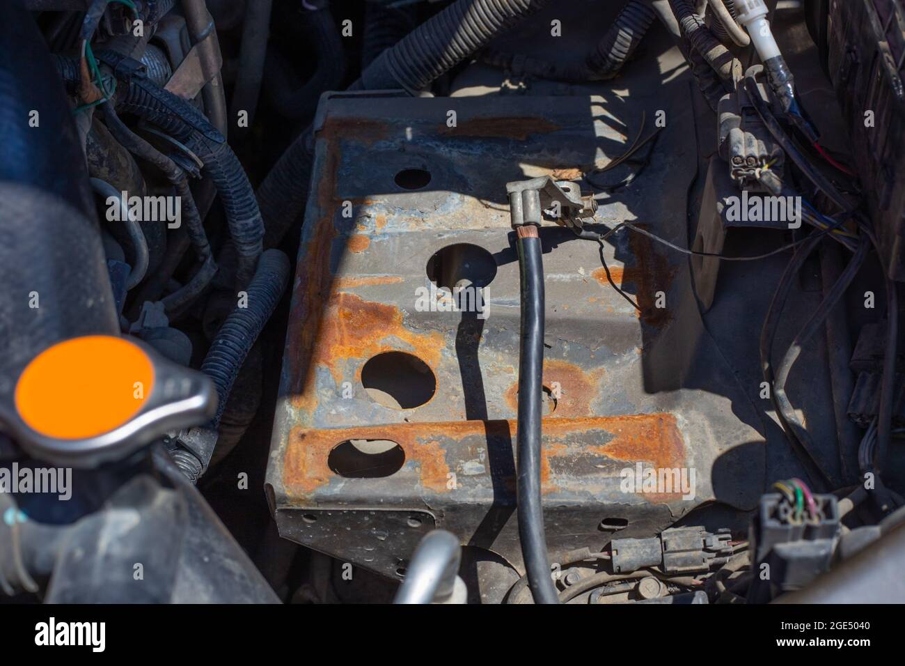 The battery pad in the car is rusted from a hydrochloric acid leak. Installation and replacement of batteries. Stock Photo