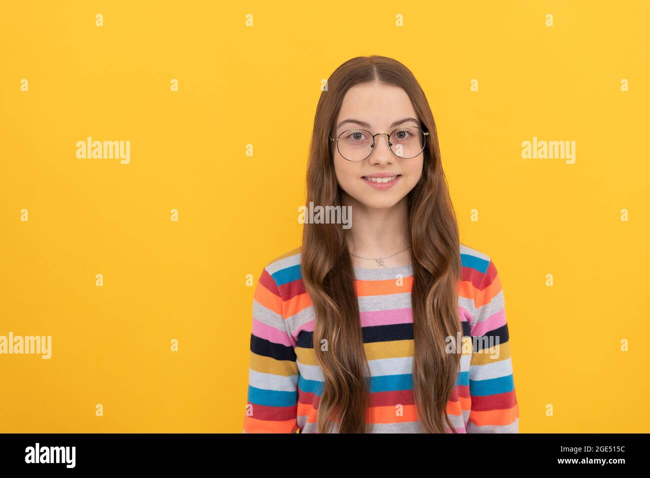 smiling schoolgirl nerd child in eyeglasses for vision, school Stock Photo