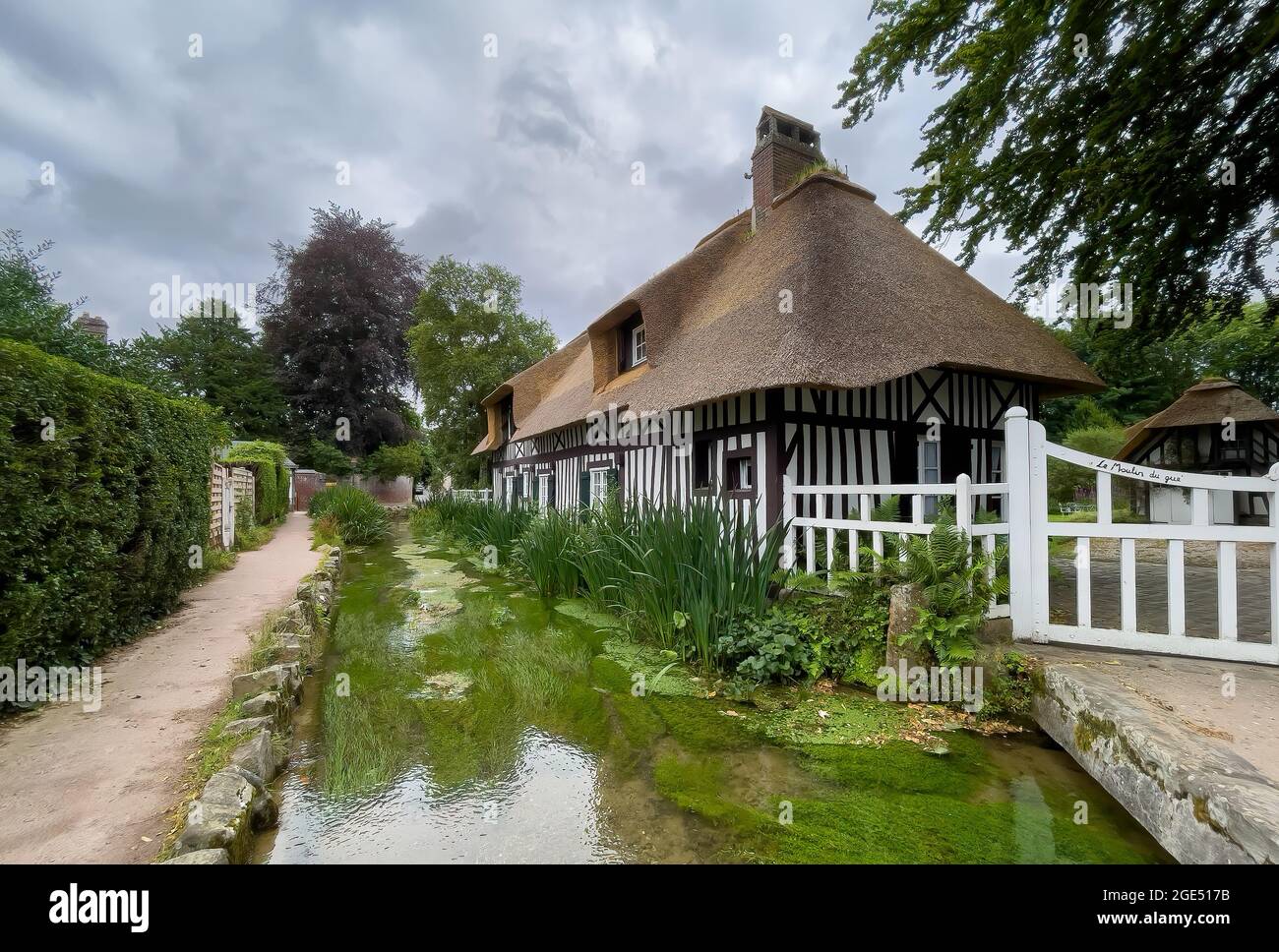Veules les Roses, France - July 30, 2021: Old traditional house of Normandy and the river Veules, the shortest sea-bound river in France at 1.194 kilo Stock Photo