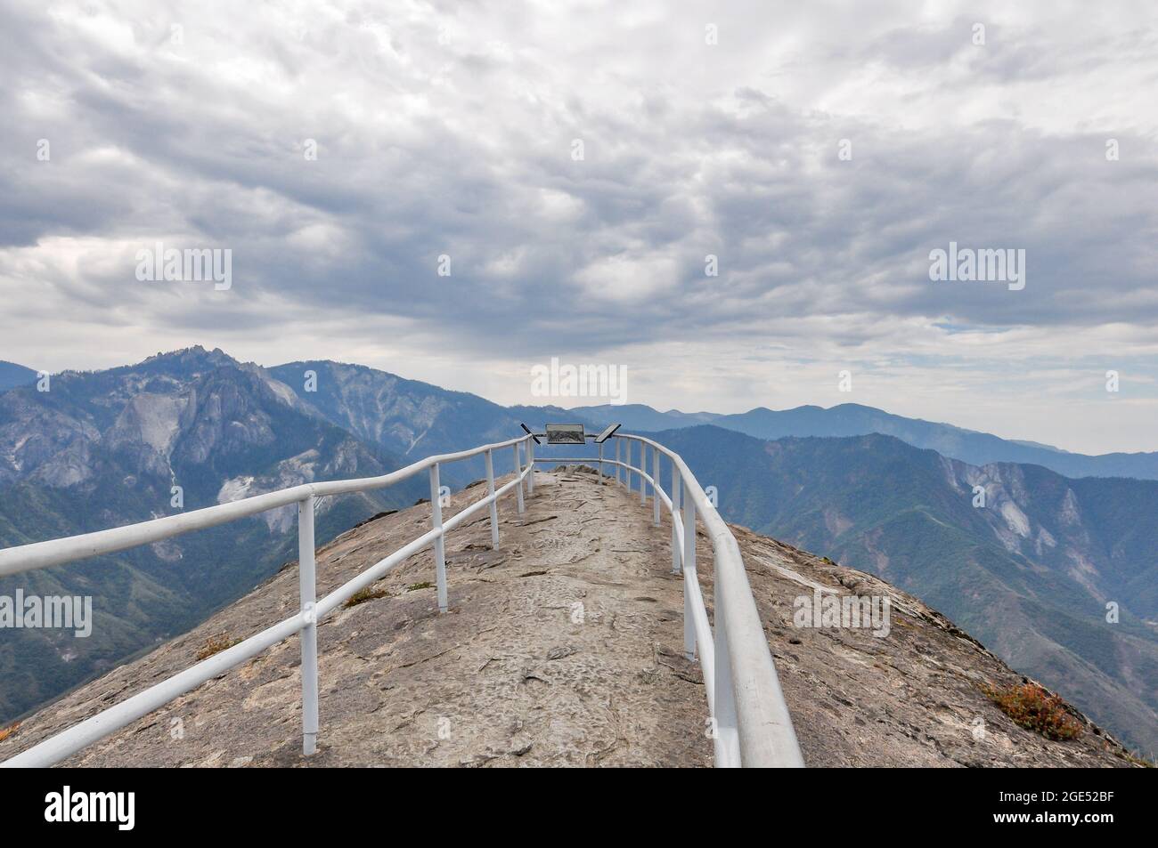 Summit of Moro Rock in Sequoia National Park shown in a rare moment with no people. The end of the hiking trail is fenced in by safety railings extend Stock Photo