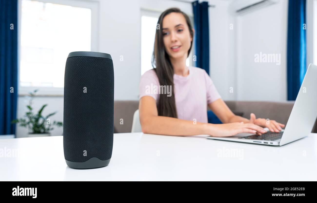 Woman using smart speaker, smart home system appliance, modern ...