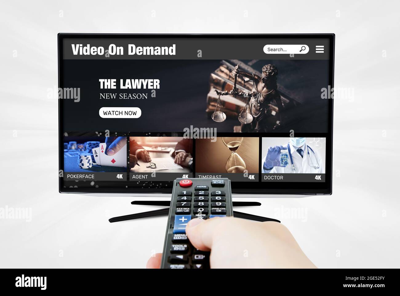 Video on demand, TV streaming, multimedia. Hand holding remote control Stock Photo