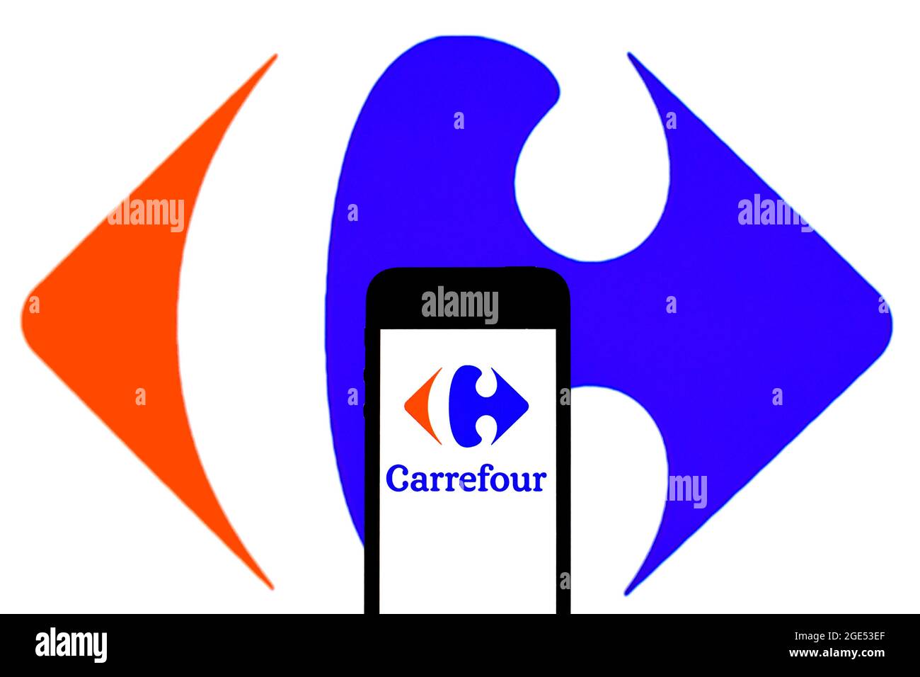 Spain. 11th Aug, 2021. In this photo illustration, a Carrefour logo seen displayed on a smartphone and in the background. (Photo by Thiago Prudencio/SOPA Images/Sipa USA) Credit: Sipa USA/Alamy Live News Stock Photo