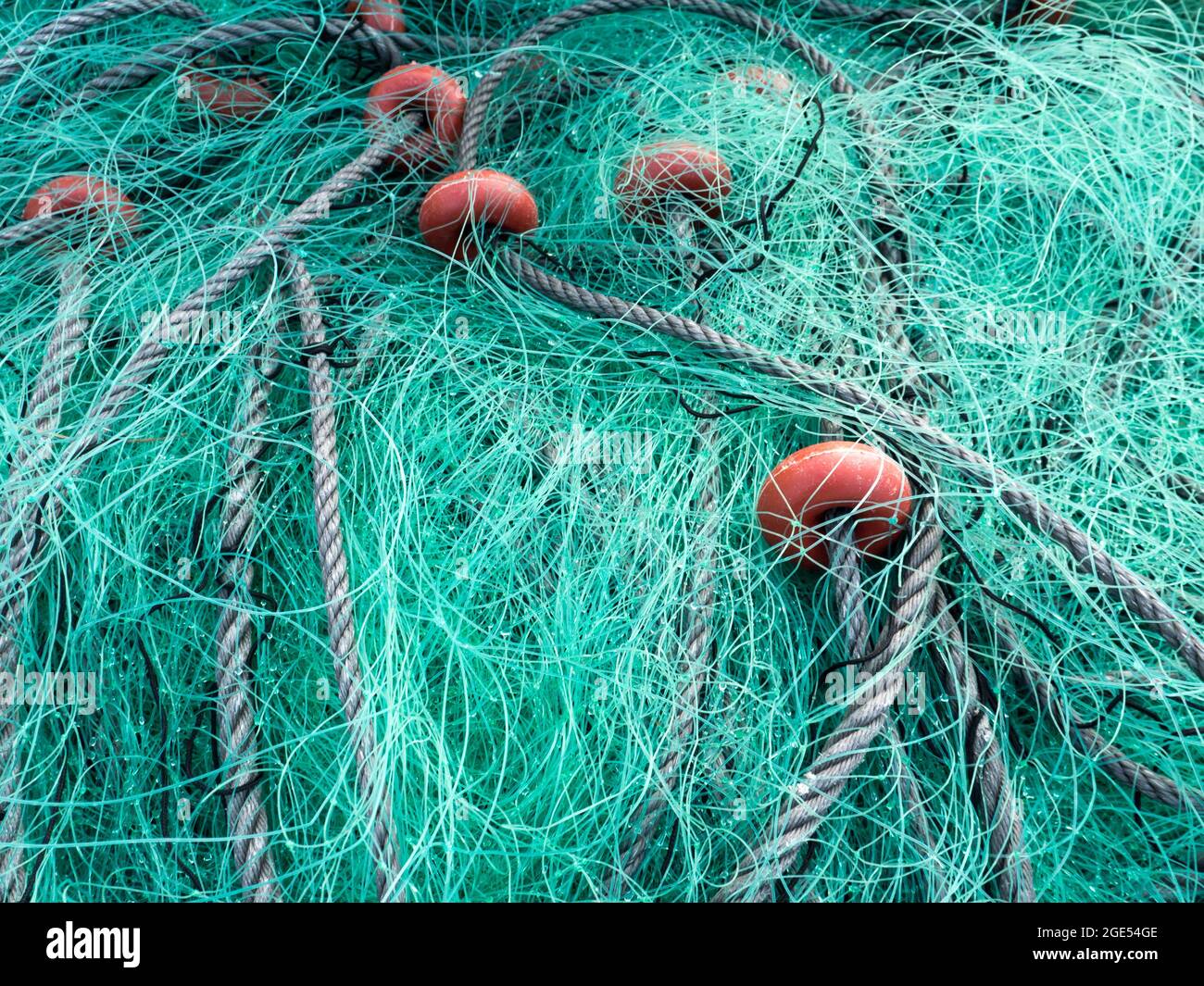 LUARCA, SPAIN - DECEMBER 4, 2016: Green fishing net at the fish market pier in Luarca, Spain. Stock Photo