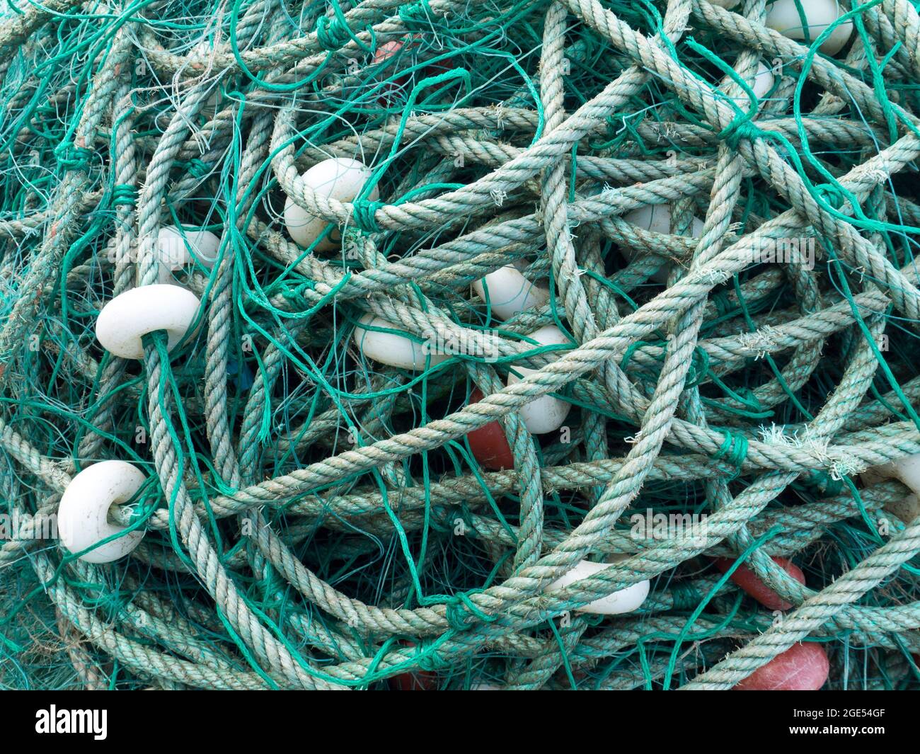 LUARCA, SPAIN - DECEMBER 4, 2016: Green fishing net with white floats at the fish market pier in Luarca, Spain. Stock Photo