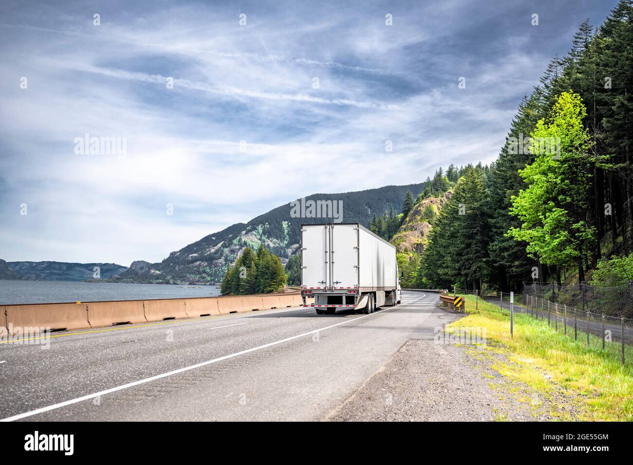 Industrial long hauler big rig white semi truck tractor transporting ...