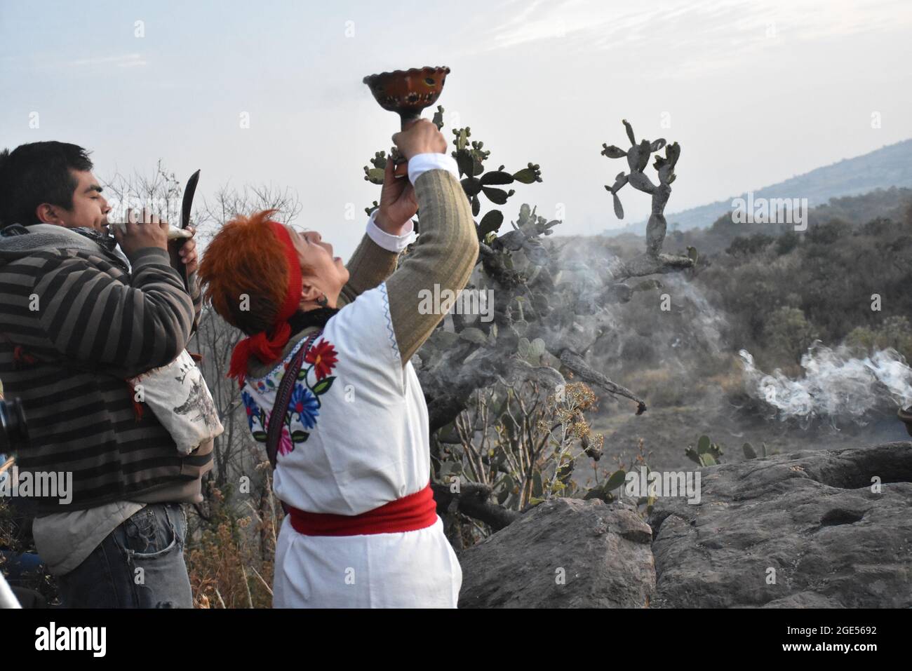 An indigenous shaman performs a ritual to the four cardinal points before dawn on the winter solstice. Stock Photo