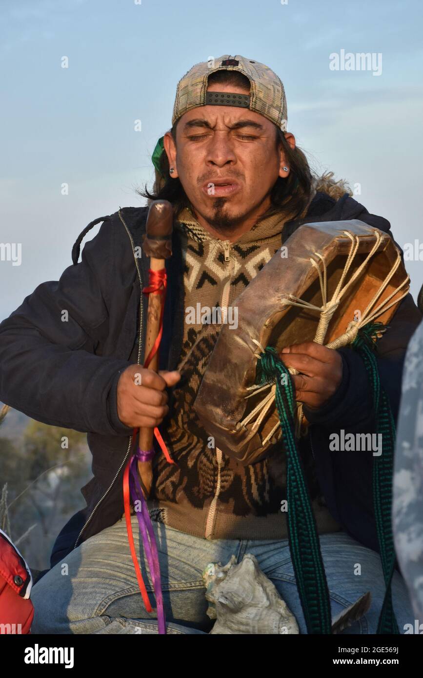 An indigenous musician plays a traditional drum during the ritual to ...