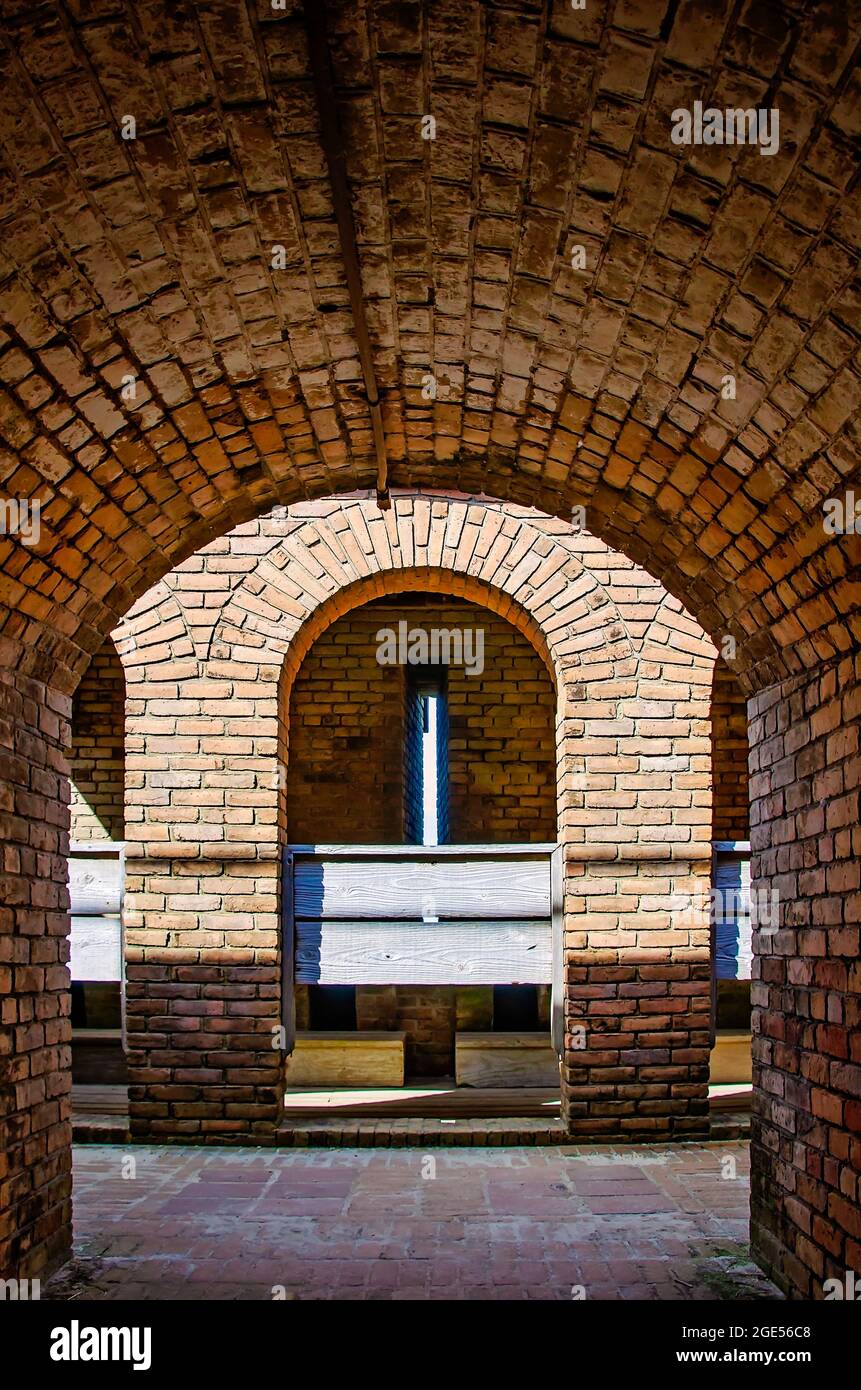 A tunnel leads to the latrine at Fort Gaines, Aug. 12, 2021, in Dauphin Island, Alabama. The 10-seat latrine was “self-flushing.' Stock Photo