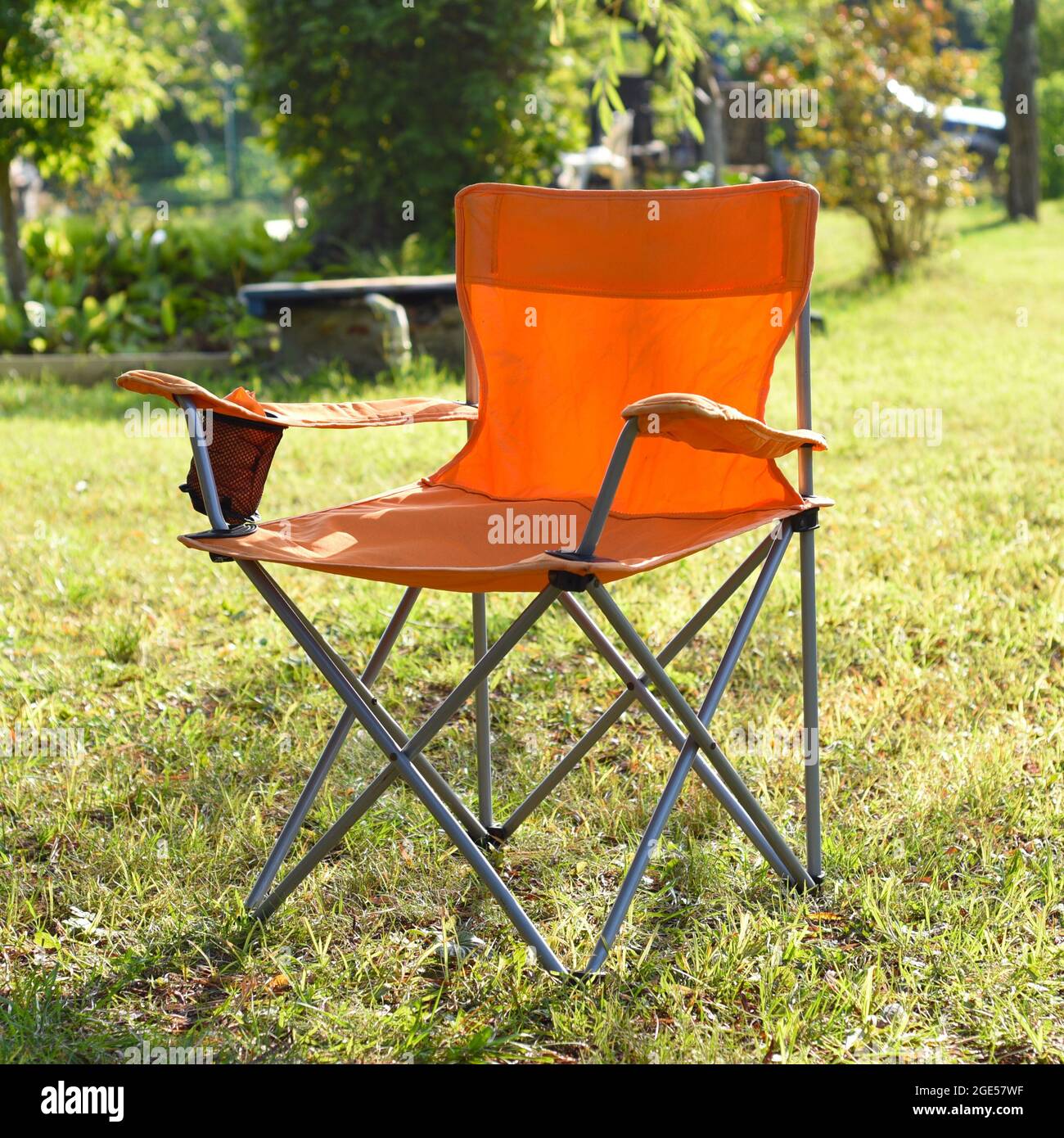 folding tourist chair standing outdoors on the grass Stock Photo Alamy
