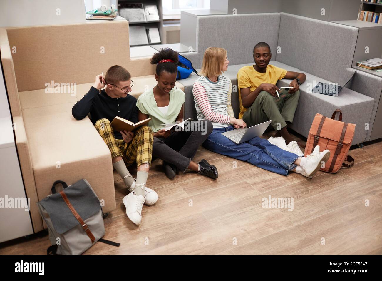 High angle view at diverse group of young students studying together ...