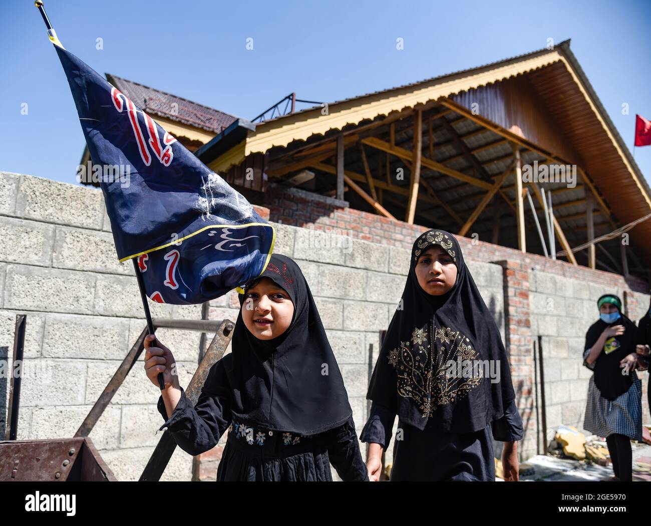 Srinagar, India. 16th Aug, 2021. A Kashmiri Shia girl hold a religious ...