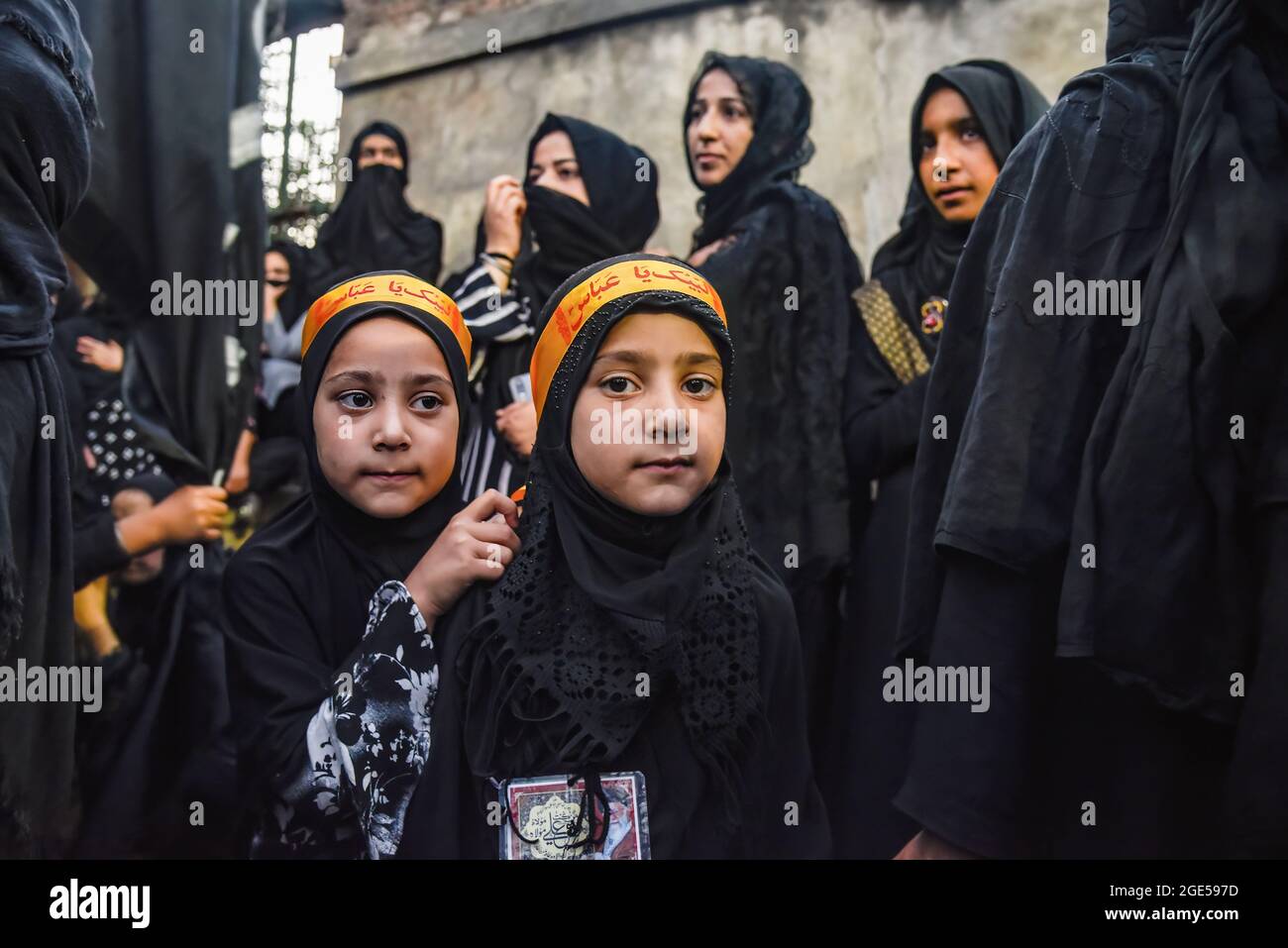 Kashmiri Shia Muslim girls wearing hijab pose for a picture during a  Muharram procession in Srinagar. Muharram is the first month of Islam. It  is one of the holiest months in the