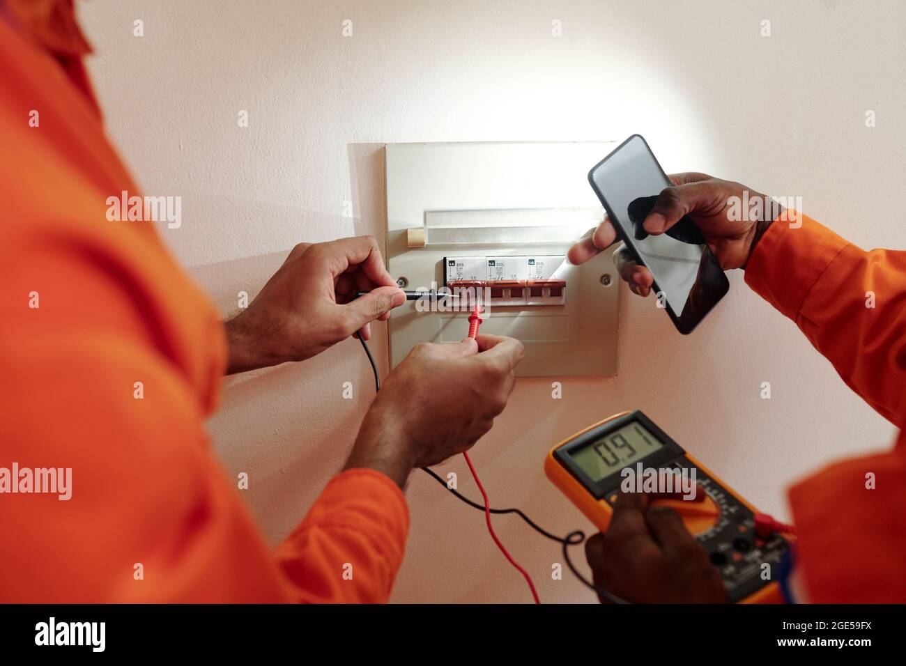 Hands of technicians using multimeter when testing electric current in