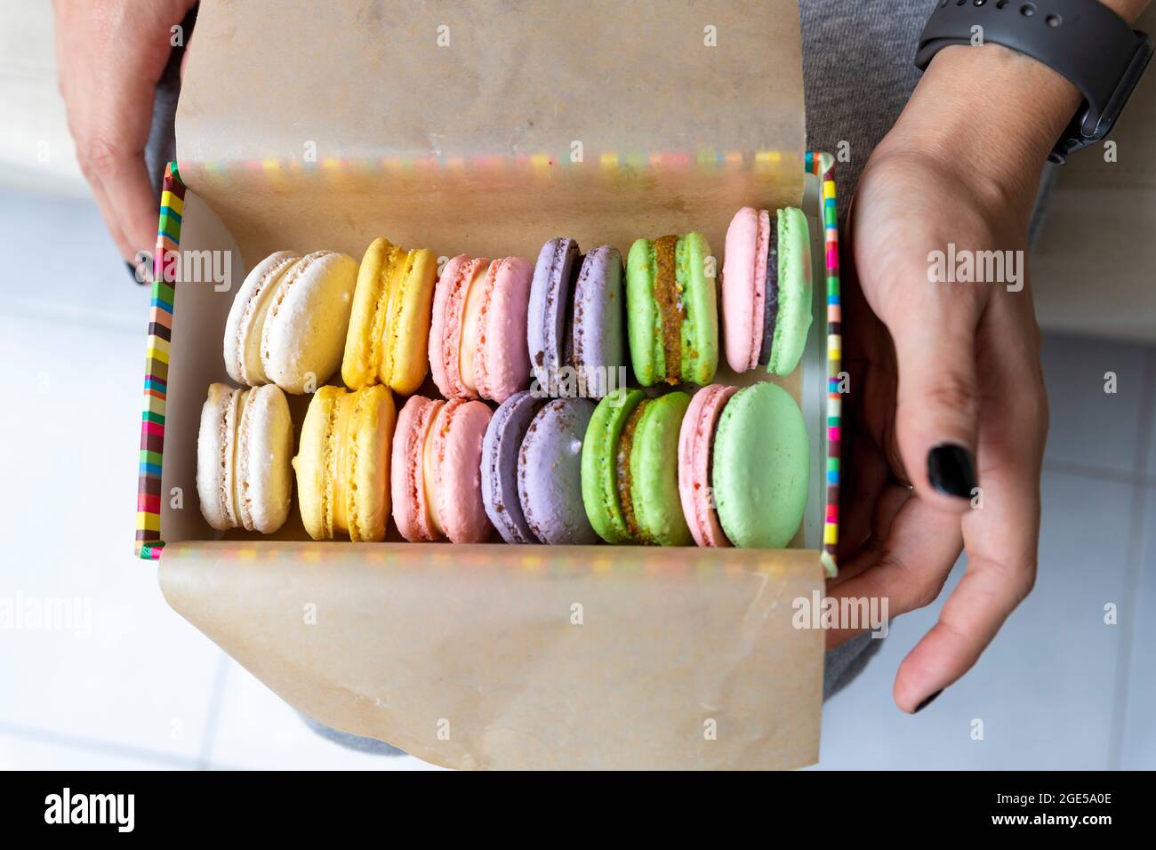 Multicolored sweet macaroons or macaroon flavored cookies in a paper box Stock Photo