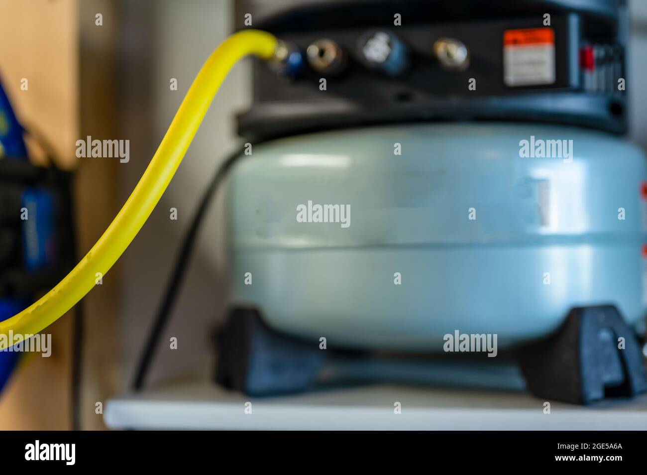 Selective focus on a hose connected to a Pancake air compressor sitting