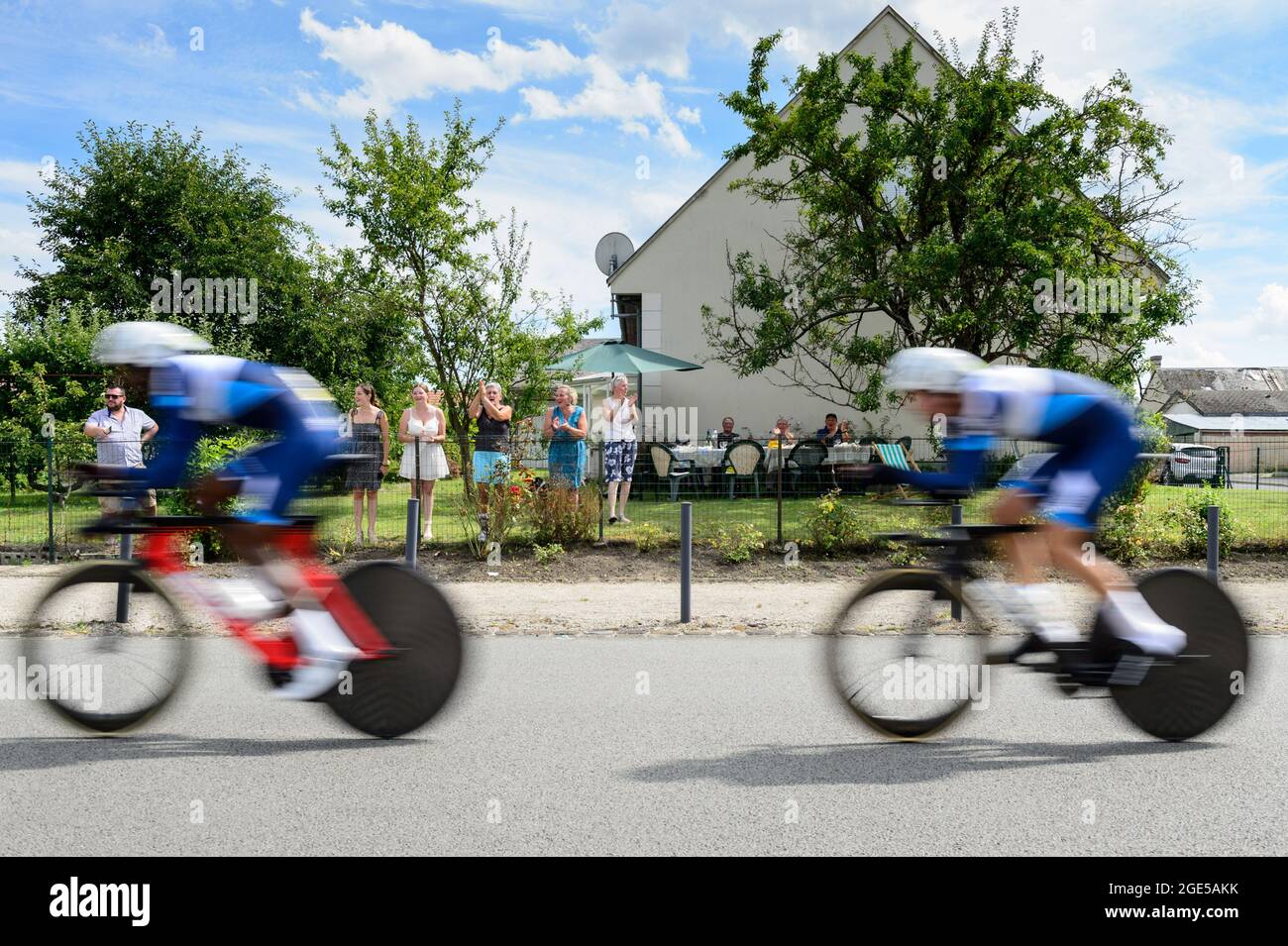 Etouvelles, France. 15th Aug, 2020. Members of the UCI Youth in Training team are seen in action in the team time trial as a family cheers the riders from the backyard. The second stage of the Tour de l'Avenir 2021 is a team time trial in a circuit around the city of Laon on August 15th. Tour de l'Avenir is a cycling competition taking place from August 13 to 22, 2021 and reserved for cyclists under 23 years old. The winner of second first stage is the Netherlands team. (Photo by Laurent Coust/SOPA Images/Sipa USA) Credit: Sipa USA/Alamy Live News Stock Photo