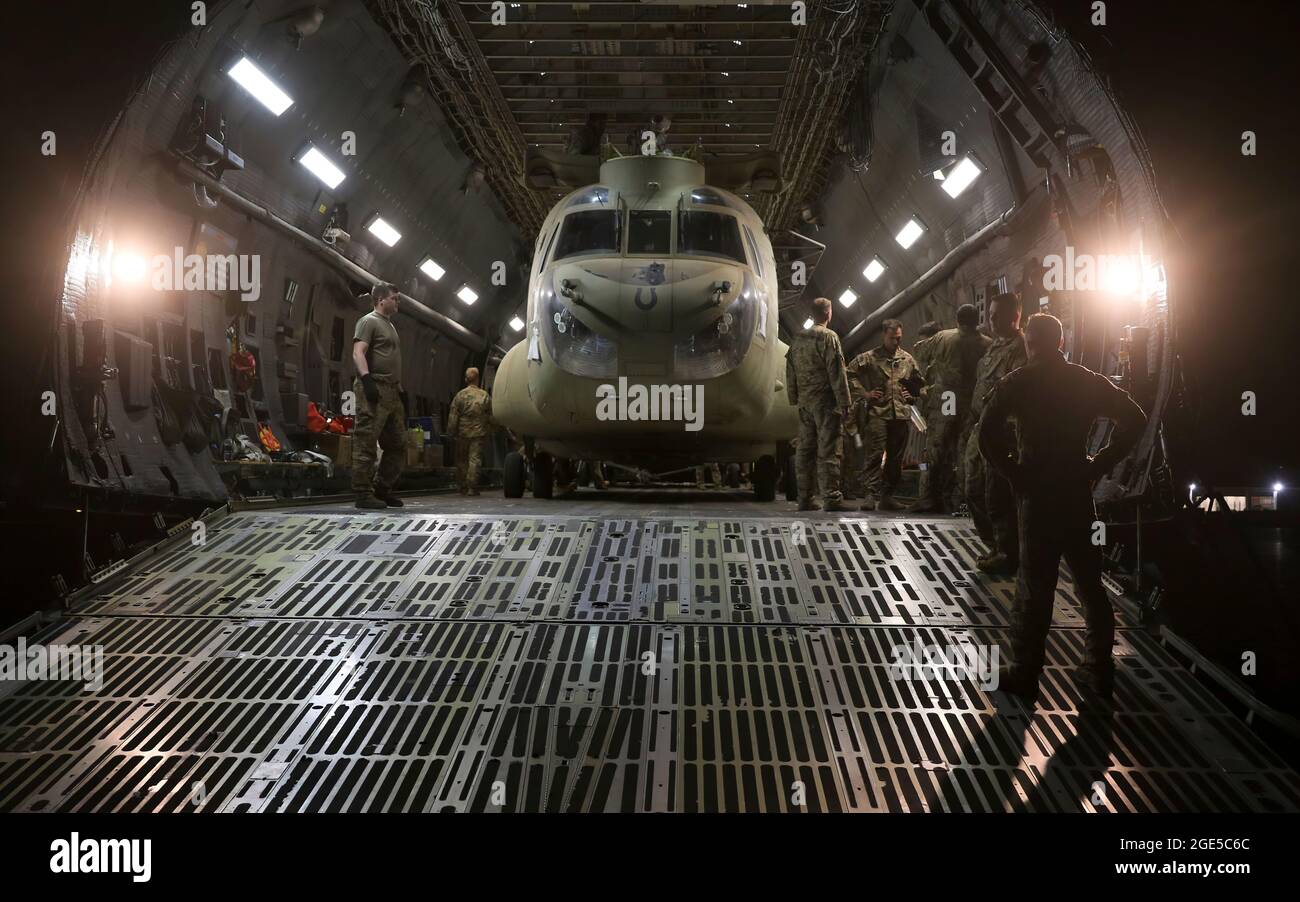 Aerial porters work with maintainers to load a CH-47 Chinook into a C-17 Globemaster III in support of the Resolute Support retrograde mission in Afghanistan, June 16, 2021. (U.S. Army photo by Sgt. 1st Class Corey Vandiver) Stock Photo