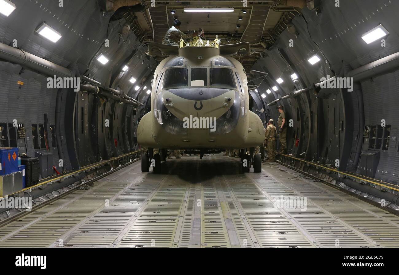 Aerial porters work with maintainers to load a CH-47 Chinook into a C-17 Globemaster III in support of the Resolute Support retrograde mission in Afghanistan, June 16, 2021. (U.S. Army photo by Sgt. 1st Class Corey Vandiver) Stock Photo