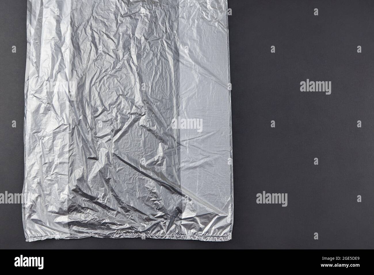 Three plastic bag on dark background, environmental pollution concept. Stock Photo