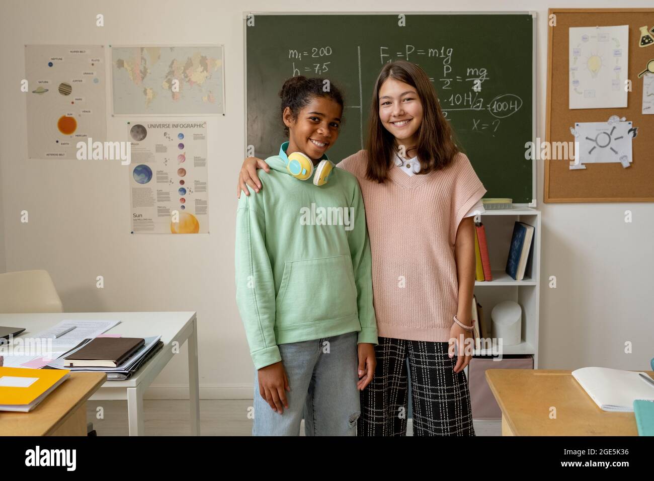 Two smiling schoolgirls in classroom hi-res stock photography and ...