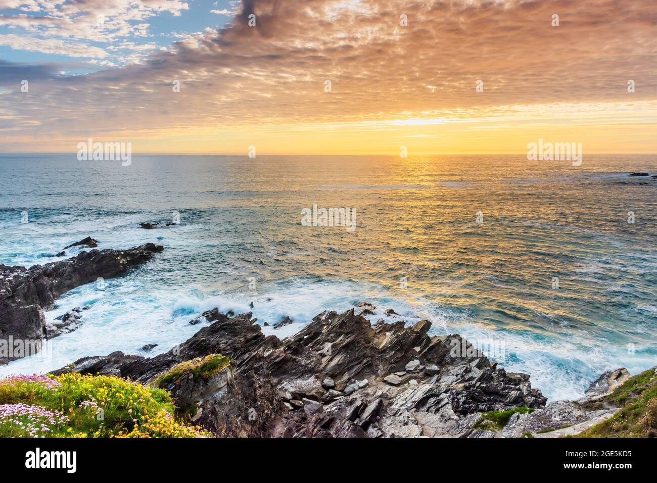 A spectacular sunset over the Celtic Sea seen from the coast of Newquay in Cornwall. Stock Photo