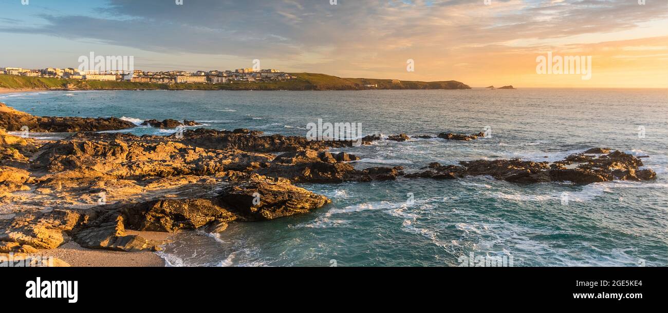 A panoramic image of an intense sunset over Fistral Bay on the coast of Newquay in Cornwall. Stock Photo