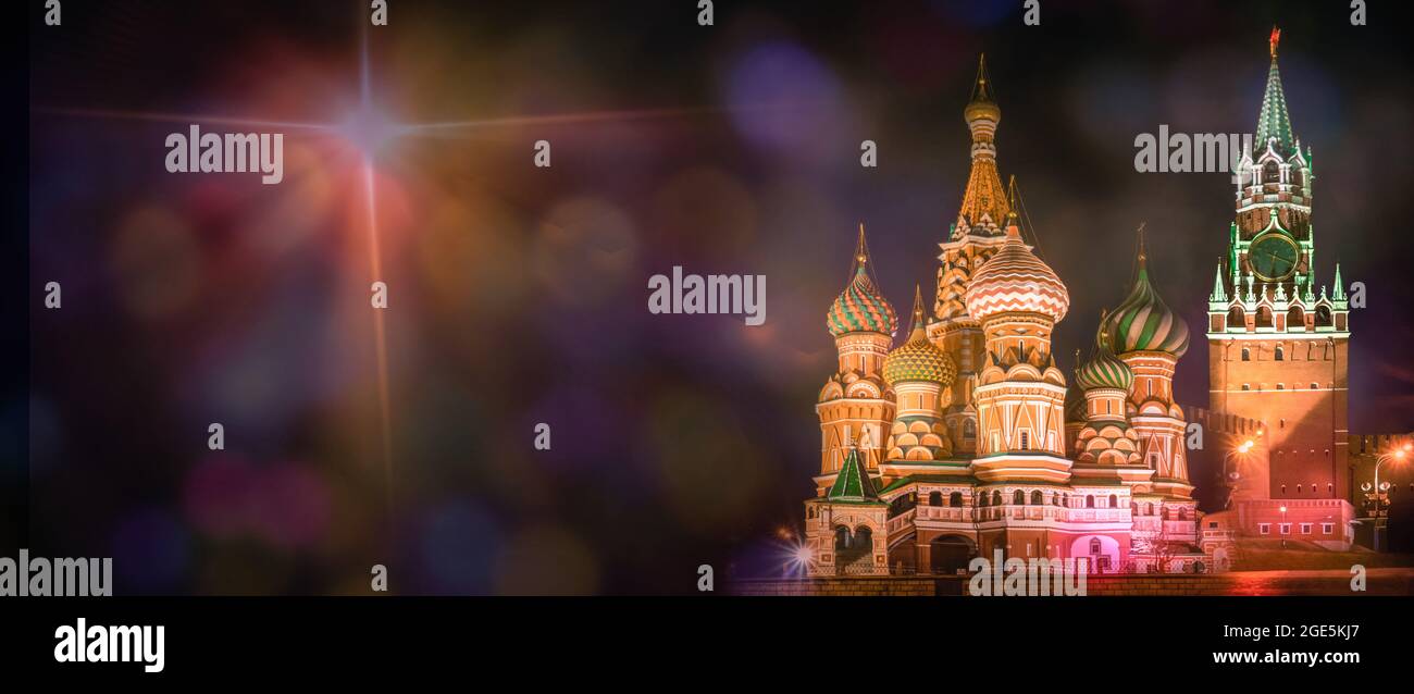 Night illuminated Red Square, Moscow, Russia. St Basil cathedral and Spasskaya tower. Copy space on black dark background with colorful bokeh spots an Stock Photo