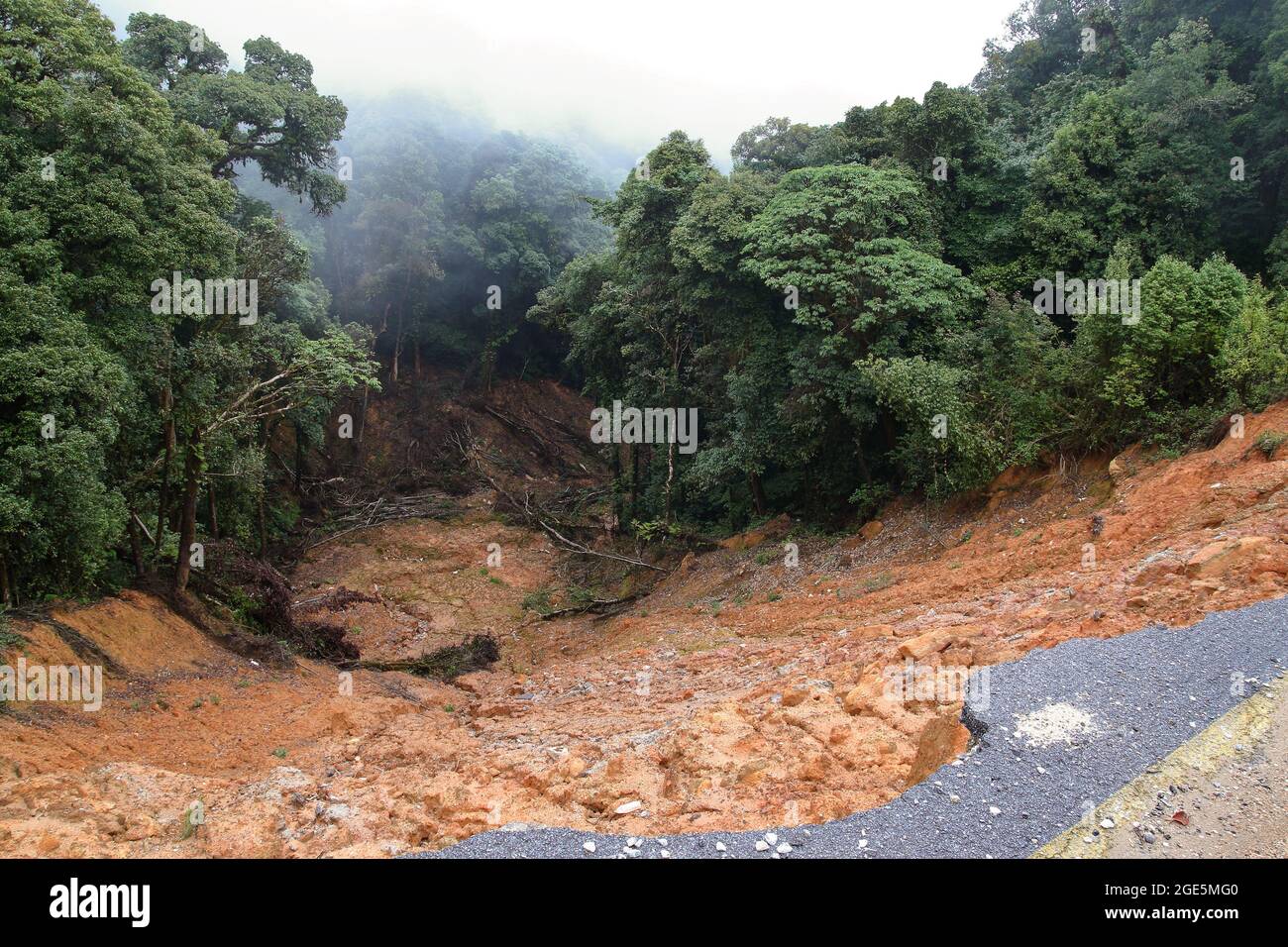 Collapse asphalt road cause by heavy rain due to foothill landslide Stock Photo