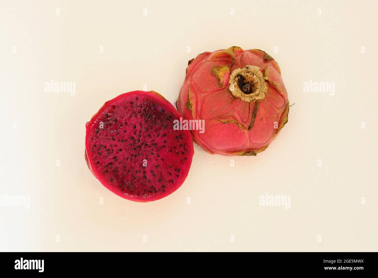 Pitaya or dragon fruit with dark pink centre cut in half Stock Photo