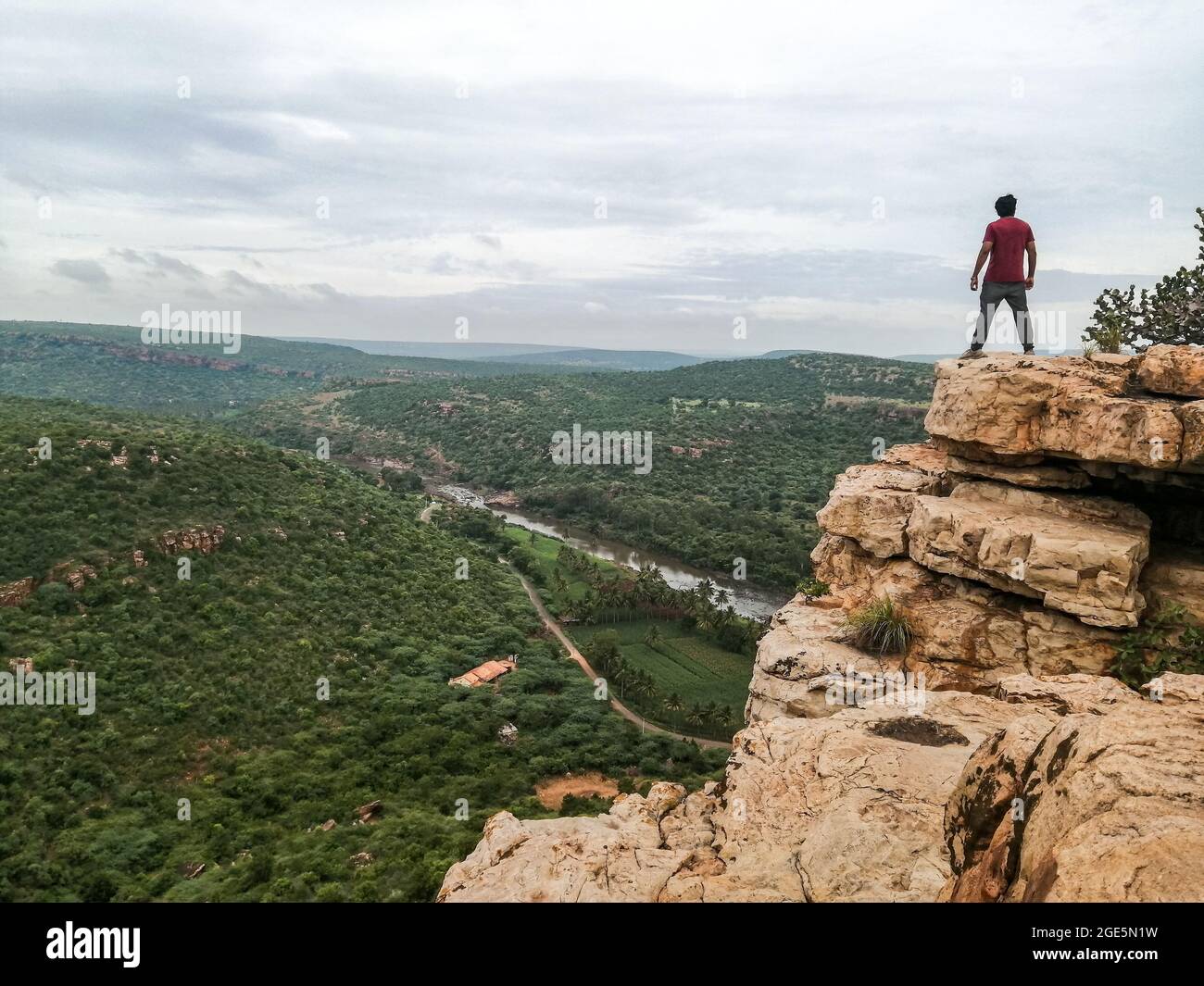 29 July 2020 Markandeya Valley, Gokak, Karnataka, India : Person standing on mountain top overlooking the Markandeya Valley, Stock Photo